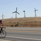 Multiple styles of wind turbines in various states of repair on Altamont Pass. Oh, and a biker.